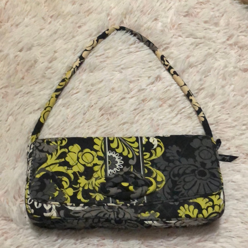 It’s a Vera Bradley purse It’s a clutch it is gray yellow black and white